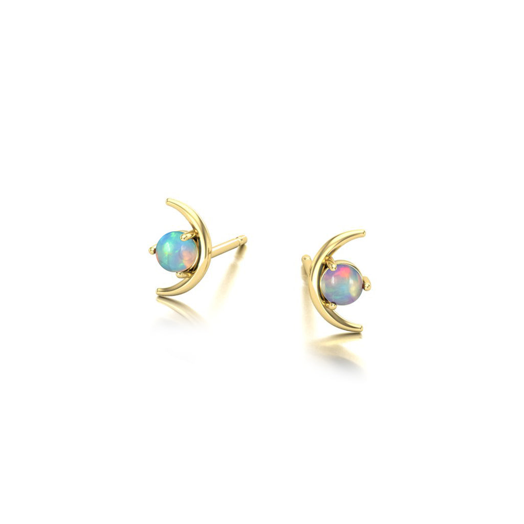 Gold moon shaped earrings with opal gemstones stones on a white background angle view