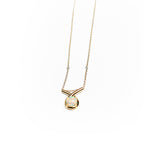 Gold loop pendant necklace with a white opal on a white background