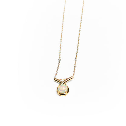Gold loop pendant necklace with a white opal on a white background