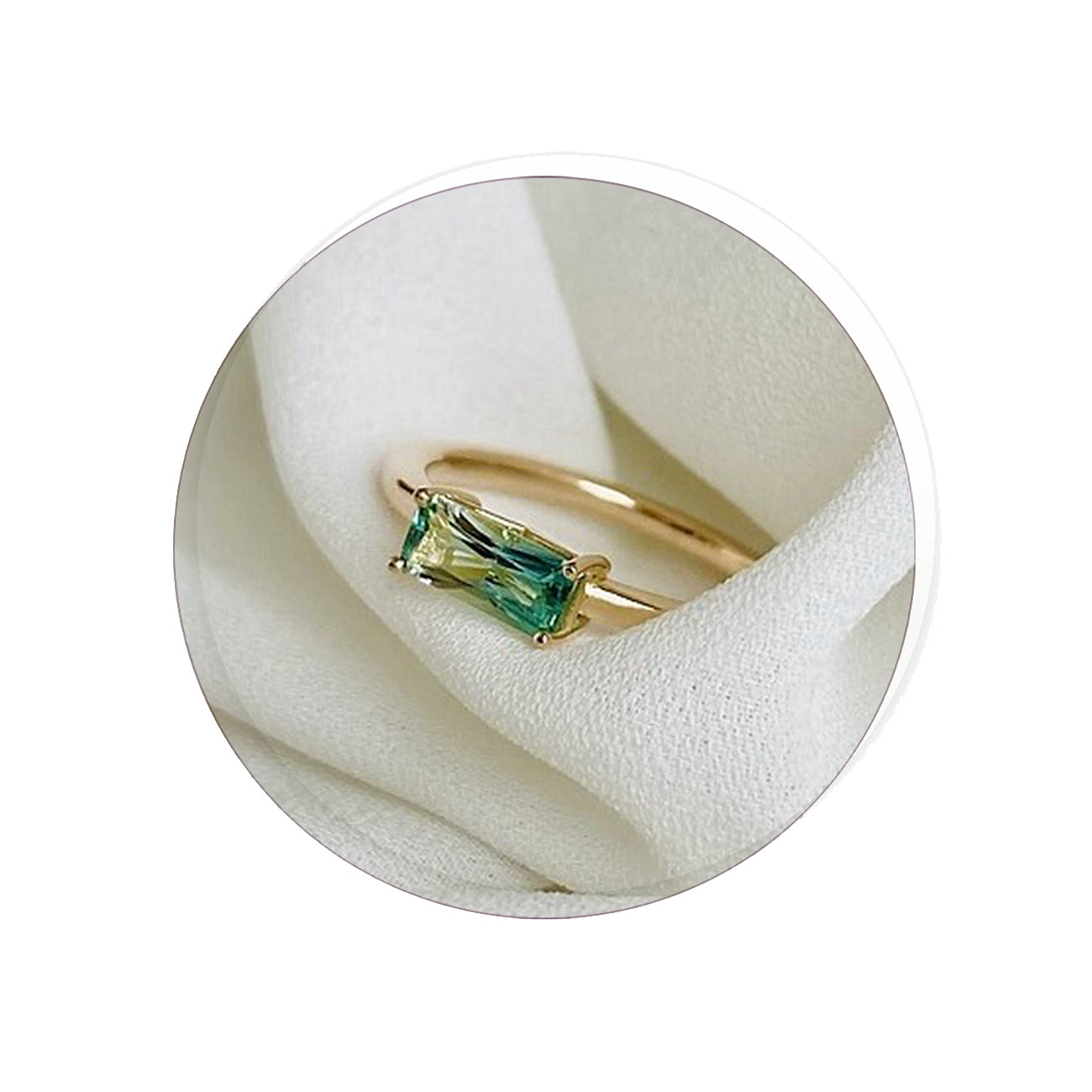 14K yellow gold ring with a green bicolor tourmaline gemstone on a white background
