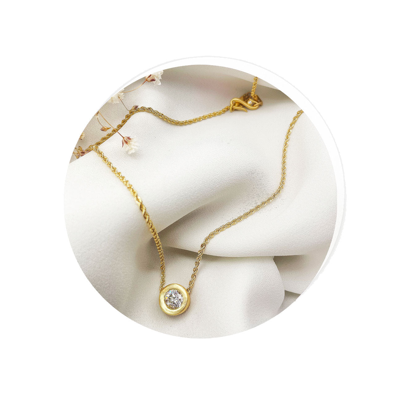 18k yellow gold necklace with a diamond bezel pendant on a white background