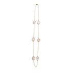 Long necklace with keshi pearls stationed on a delicate yellow gold chain on white background