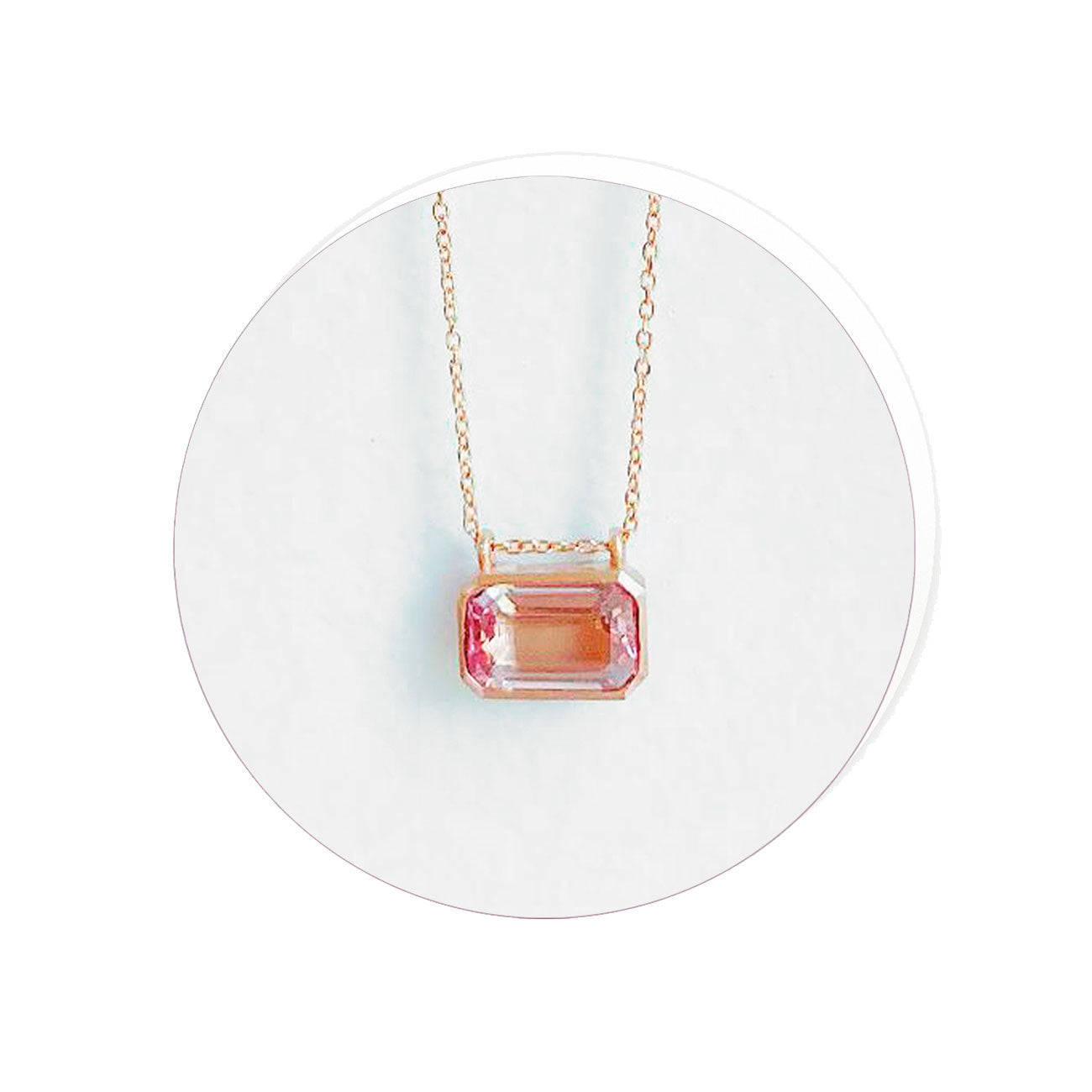 Necklace with a pink gemstone pendant on a white background