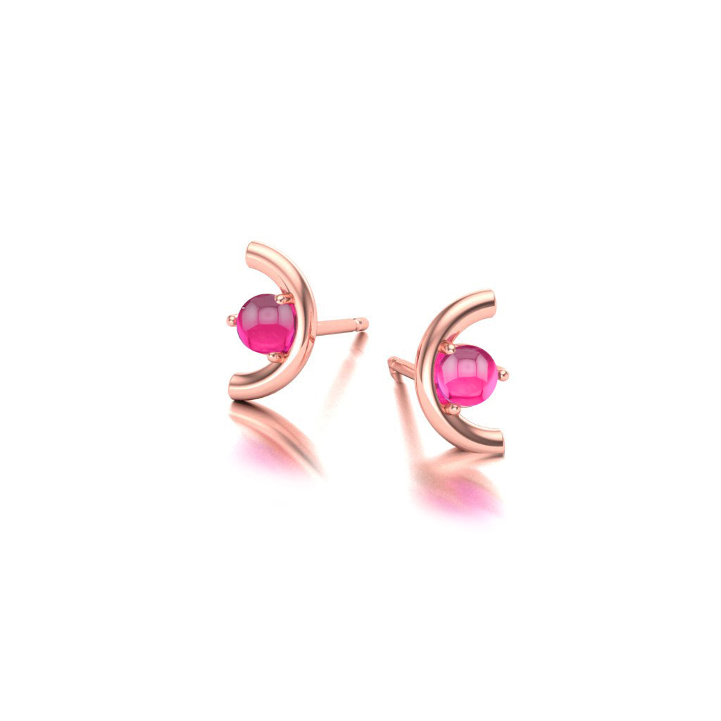Rose gold earrings with pink garnet gemstones on a white background angle view