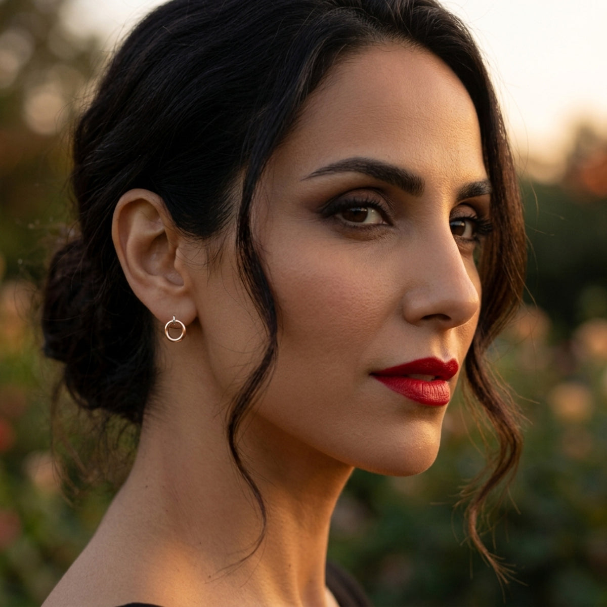 woman with red lipstick and blurred natural background wearing mini pure radiance earrings by Jillery