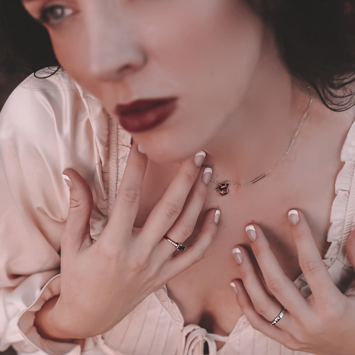 muse necklace and lucky 7 ring worn by model with red lip in outdoor setting