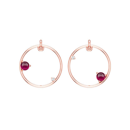 Rose gold hoop earrings with reddish pink garnet gemstones on a white background