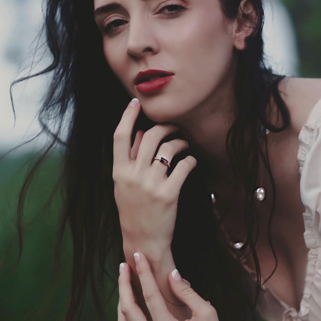 rose gold lucky 7 ring and haven station necklace worn by model with red lip in outdoor setting and very wispy natural hair