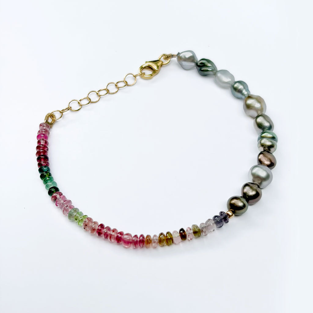 A multicolor beaded and pearl necklace bracelet with a gold clasp, displayed on a clean white background.